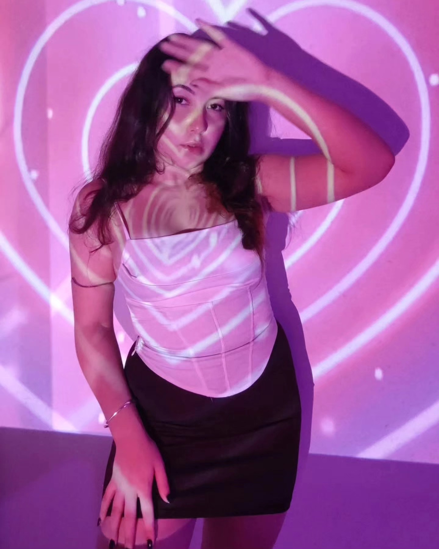Sanshaine Moura em uma instalação de luz rosa